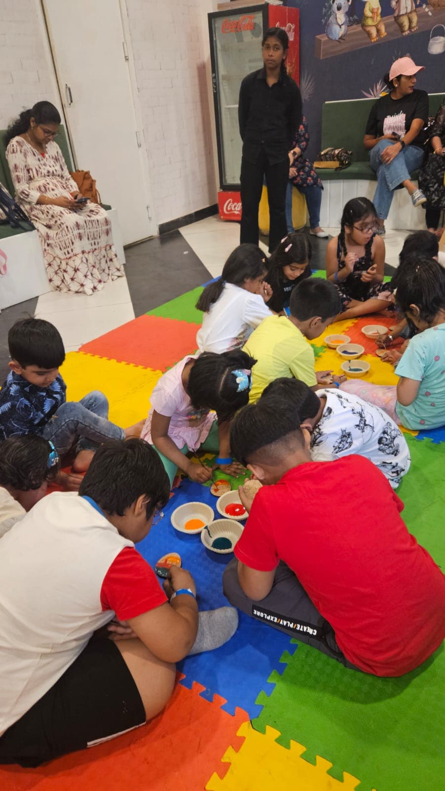 Families playing on a giant BoredomBox event mat